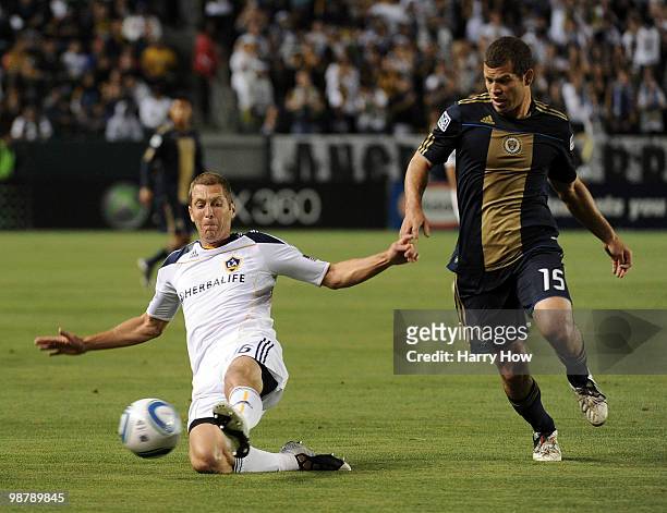 Gregg Berhalter of the Los Angeles Galaxy clears a ball in front of Alejandro Moreno of the Philadelphia Union during the first half at the Home...
