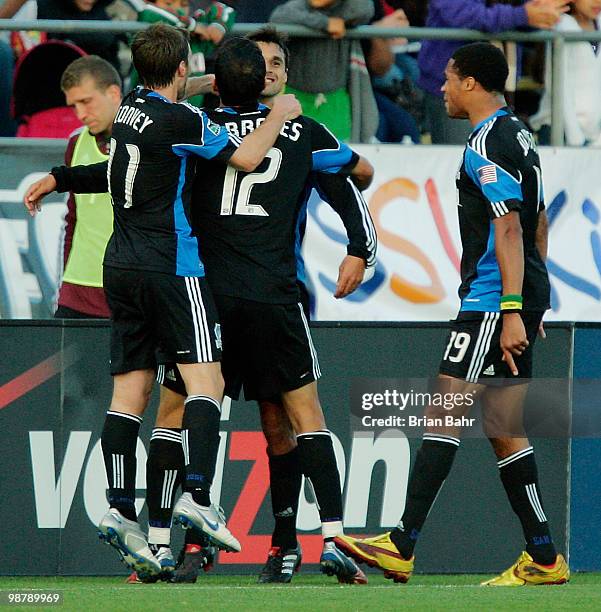 Chris Wondolowski of the San Jose Earthquakes gets congratulated after scoring a goal against the Colorado Rapids in the first half on May 1, 2010 at...