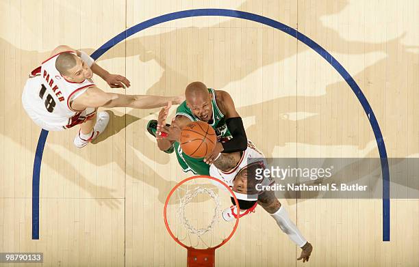 Ray Allen of the Boston Celtics shoots against Mo Williams and Anthony Parker of the Cleveland Cavaliers in Game One of the Eastern Conference...