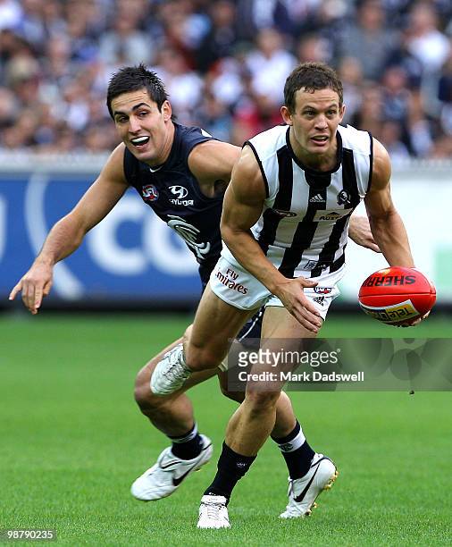 Luke Ball of the Magpies breaks away from Kane Lucas of the Blues during the round six AFL match between the Carlton Blues and the Collingwood...