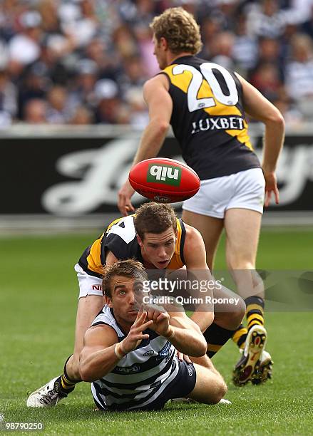 Corey Enright of the Cats handballs during the round six AFL match between the Geelong Cats and the Richmond Tigers at Skilled Stadium on May 2, 2010...