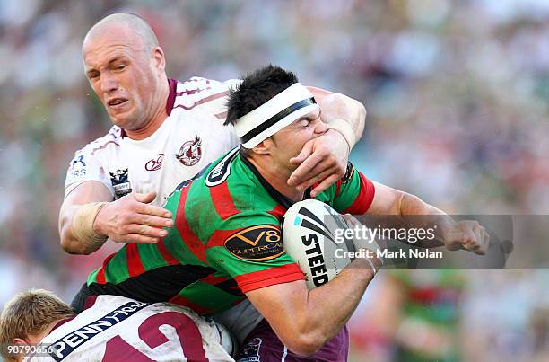 Beau Champion of the Rabbitohs is tackled high by Matt Cross of the Eagles during the round eight NRL match between the South Sydney Rabbitohs and...