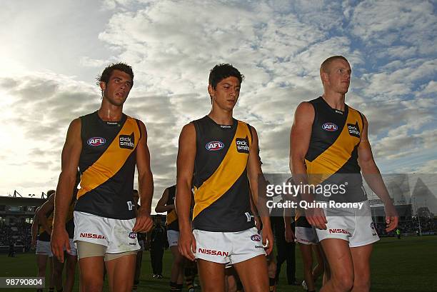 Alex Rance, Robin Nahas and Kelvin Moore of the Tigers leave the ground after losing the round six AFL match between the Geelong Cats and the...