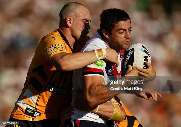Anthony Minichiello of the Roosters is tackled by Liam Fulton of the Tigers during the round eight NRL match between the Wests Tigers and the Sydney...