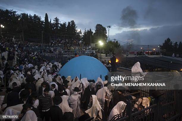 Ultra Orthodox Jews pray at the grave site of Rabbi Shimon Bar Yochai in the northern Israeli village of Meron, early on May 2, 2010 during the...
