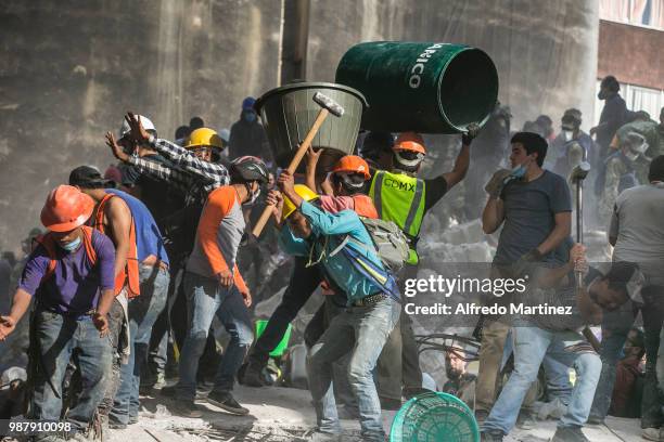 Rescuers, volunteers and firefighters work after the magnitude 7.1 earthquake that jolted central Mexico damaging buildings, knocking out power and...