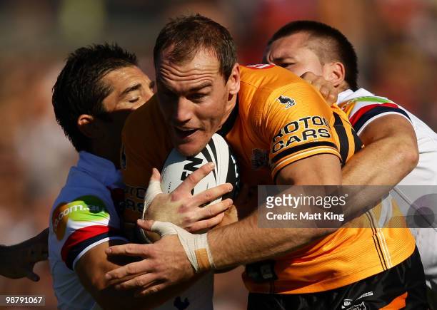 Gareth Ellis of the Tigers takes on the defence during the round eight NRL match between the Wests Tigers and the Sydney Roosters at Campbelltown...