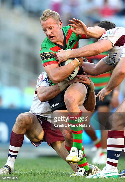 Jason Clark of the Rabbitohs is tackled during the round eight NRL match between the South Sydney Rabbitohs and the Manly Sea Eagles at ANZ Stadium...
