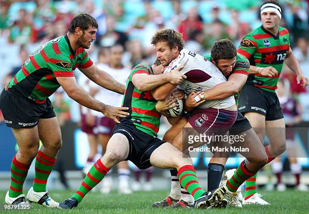Josh Perry of the Eagles is tackled during the round eight NRL match between the South Sydney Rabbitohs and the Manly Sea Eagles at ANZ Stadium on...