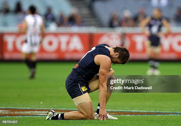 Marc Murphy of the Blues struggles to regain his feet during the round six AFL match between the Carlton Blues and the Collingwood Magpies at...