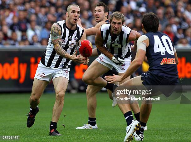 Dane Swan of the Magpies handpasses during the round six AFL match between the Carlton Blues and the Collingwood Magpies at Melbourne Cricket Ground...