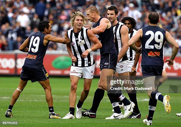 Dale Thomas of the Magpies wrestles with Eddie Betts and Sam Jacobs of the Blues during the round six AFL match between the Carlton Blues and the...