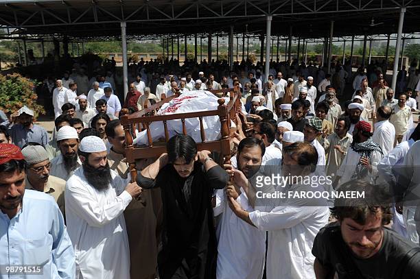 Pakistani relatives and supporters of Khalid Khawaja, a former Inter-Services Intelligence officer, carry his coffin during a funeral ceremony in...