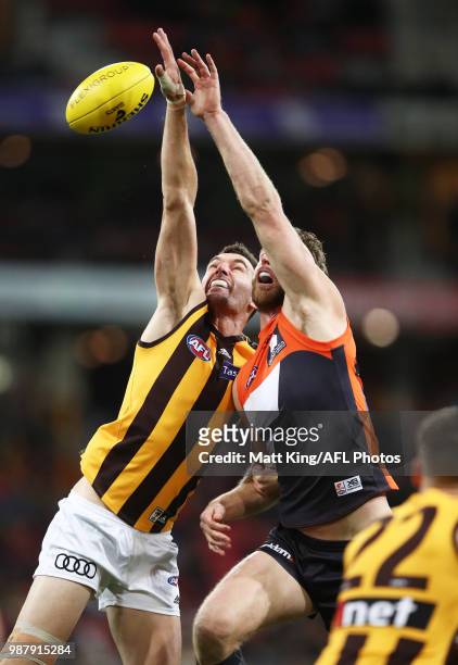 Jonathon Ceglar of the Hawks competes for the ball against Dawson Simpson of the Giants during the round 15 AFL match between the Greater Western...