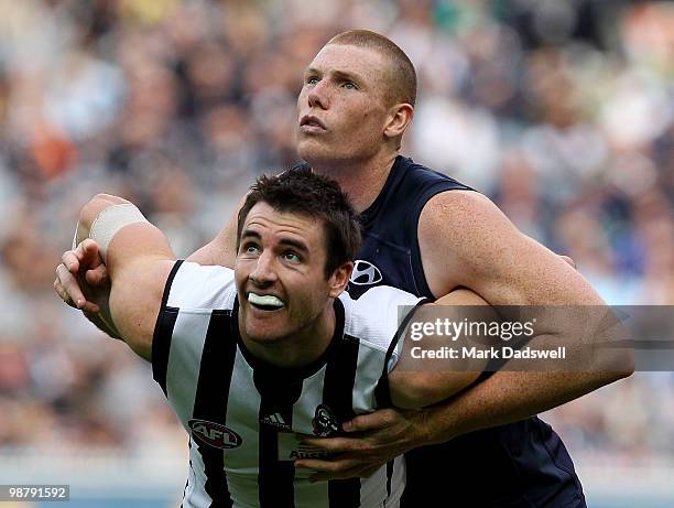 Sam Jacobs of the Blues contests a boundary throw in with Darren Jolly of the Magpies during the round six AFL match between the Carlton Blues and...