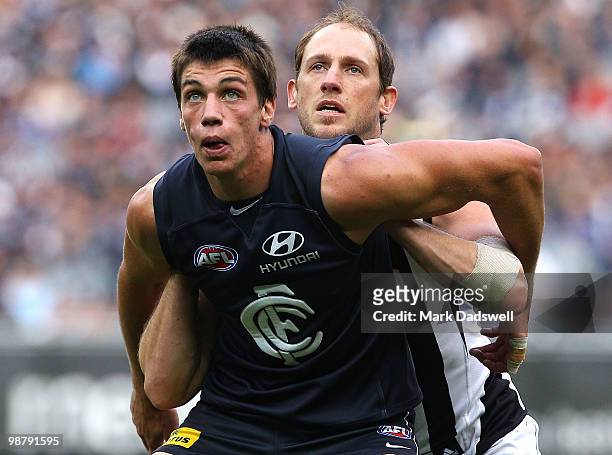 Matthew Kruezer of the Blues contests a boundary throw in with Josh Fraser of the Magpies during the round six AFL match between the Carlton Blues...