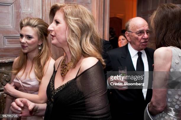 Actress Scarlett Johansson, left, and Arianna Huffington, co-founder of The Huffington Post, center, walk past Rupert Murdoch, chairman and chief...