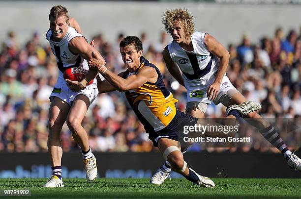 Rhys Palmer of the Dockers is tackled by Thomas Swift of the Eagles during the round six AFL match between the West Coast Eagles and the Fremantle...