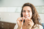 Beautiful Patient Holding Orthodontic Retainers In Dental Clinic