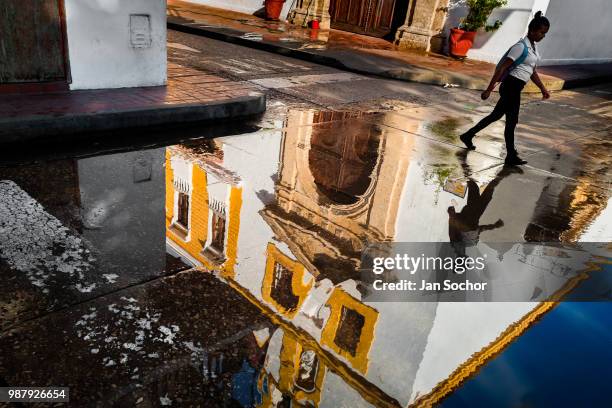 Colombian girl walks to the school in front of Santo Toribio Church, located in the colonial walled city, during a sunny morning on December 13, 2017...