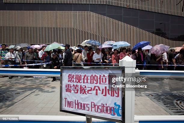 Sign indicates a two hour wait to enter a pavilion at the World Expo in Shanghai, China, on Sunday, May 2, 2010. Shanghai's $44 billion World Expo...