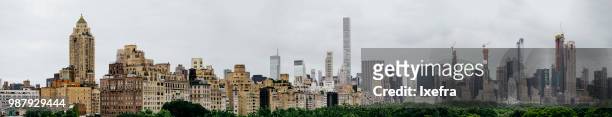 panoramic view of new york skyline over the central park, from fifth avenue. - central avenue stock pictures, royalty-free photos & images