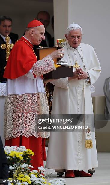 Cardinal Severino Poletto exchanges gifts with Pope Benedict XVI upon his arrival to celebrate a mass at San Carlo square in central Turin on May 2,...