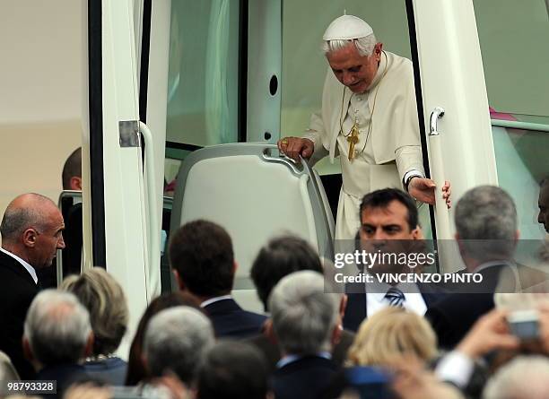 Pope Benedict XVI gets out of the popemobile as he arrives to celebrate a mass at San Carlo square in central Turin on May 2, 2010. Pope Benedict XVI...