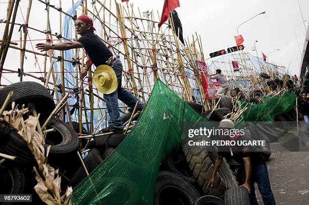 Thai "Red Shirt" protesters remove a barricade to give acces to Chulalongkorn hospital, located close to the protesters fortified camp in the...