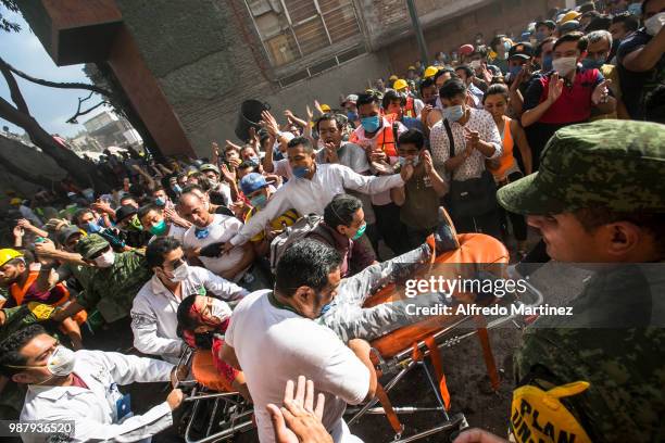 Rescuers, volunteers and firefighters work after the magnitude 7.1 earthquake that jolted central Mexico damaging buildings, knocking out power and...
