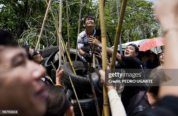 Thai "Red Shirt" protesters remove a barricade to give acces to Chulalongkorn hospital, located close to the protesters fortified camp in the...