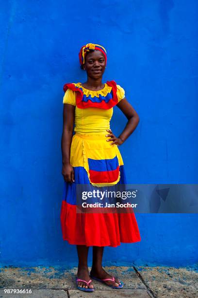 An Afro-Colombian girl, dressed in the traditional palenquera costume, poses on December 12, 2017 in Cartagena, Colombia. After the peace agreement,...