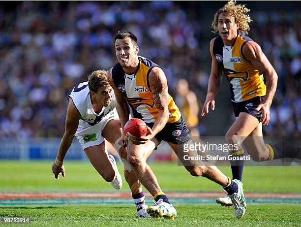 Chris Masten of the Eagles handballs away during the round six AFL match between the West Coast Eagles and the Fremantle Dockers at Subiaco Oval on...