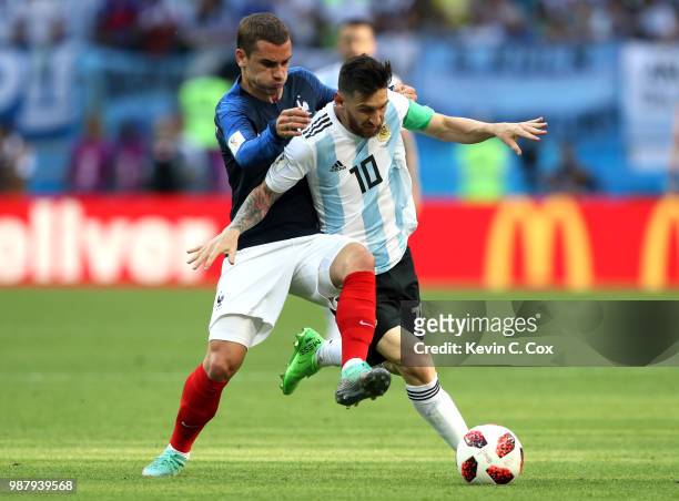 Antoine Griezmann of France challenges Lionel Messi of Argentina during the 2018 FIFA World Cup Russia Round of 16 match between France and Argentina...