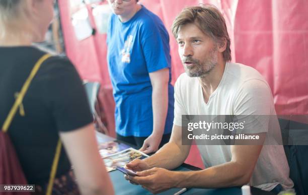 June 2018, Germany, Stuttgart: Nikolaj Coster-Waldau, actor from the series Game of Thrones, speaking to a fan during the first day of the pop...