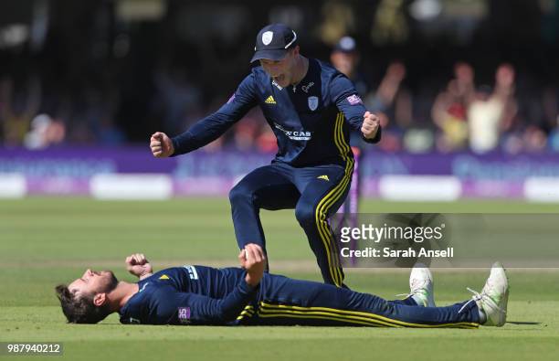 James Vince of Hampshire lies flat on his back after taking a catch to dismiss Joe Denly of Kent as teammate Tom Alsop runs to congratulate him...