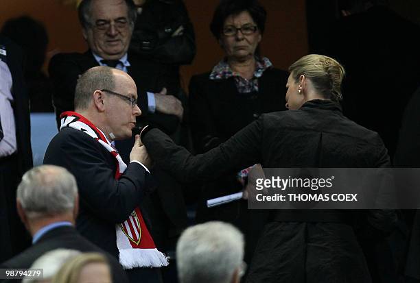 Prince Albert of Monaco kisses the hand of his girlfriend Charlene Wittstock as they arrive to attend the French Cup final football match Paris Saint...