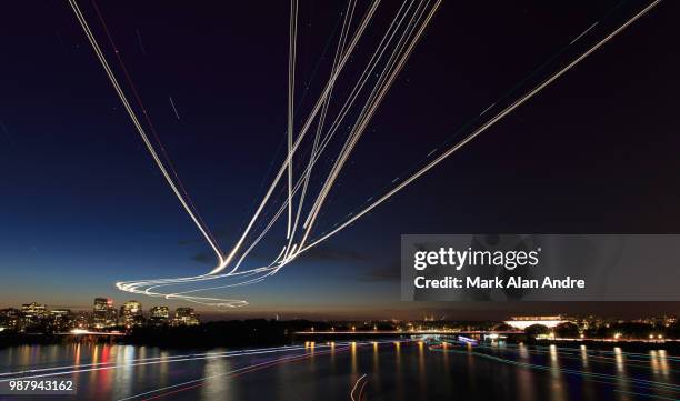 light painting on the water and in the air - airplane lights stock pictures, royalty-free photos & images