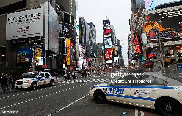 Police cruisers stand by at sunrise at the scene where a crude car bomb had been parked at 45th Street and 7th Avenue in Times Square May 2, 2010 in...