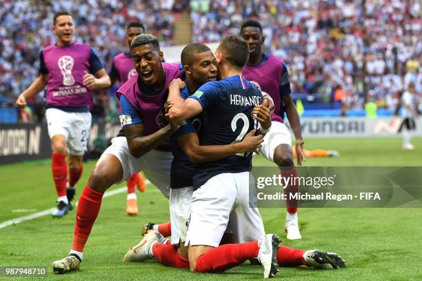 Kylian Mbappe of France celebrates after scoring his team's third goal with team mates Presnel Kimpembe and Lucas Hernandez during the 2018 FIFA...