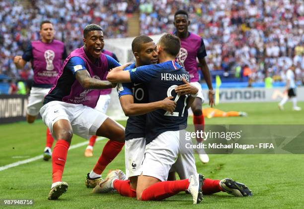 Kylian Mbappe of France celebrates after scoring his team's third goal with team mates Presnel Kimpembe and Lucas Hernandez during the 2018 FIFA...