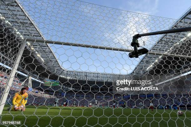 France's goalkeeper Hugo Lloris keenls after conceding a first goal to Argentina during the Russia 2018 World Cup round of 16 football match between...
