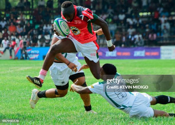 Kenya's fly-half Isaac Adimo vies with Zimbabwe's Lenience Tambwera during the 2018 Rugby African Gold Cup match between Kenya and Zimbabwe in...