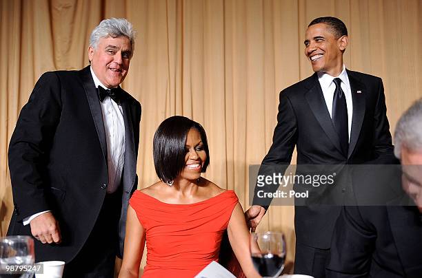 First Lady Michelle Obama is flanked by US President Barack Obama and comedian Jay Leno during the White House Correspondents' Association Dinner at...