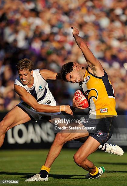 Stephen Hill of the Dockers tackles Matt Rosa of the Eagles during the round six AFL match between the West Coast Eagles and the Fremantle Dockers at...