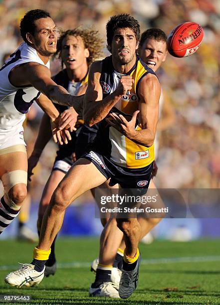 Matt Rosa of the Eagles handballs during the round six AFL match between the West Coast Eagles and the Fremantle Dockers at Subiaco Oval on May 2,...