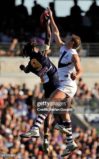 Nic Naitanui of the Eagles contests the bounce against Aaron Sandilands of the Dockers during the round six AFL match between the West Coast Eagles...
