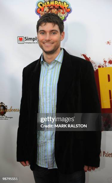 Actor Scott Maguire who plays the role of "Dana" poses on the red carpet as he arrives for the premiere of "The Road to Freedom" at the Egyptian...