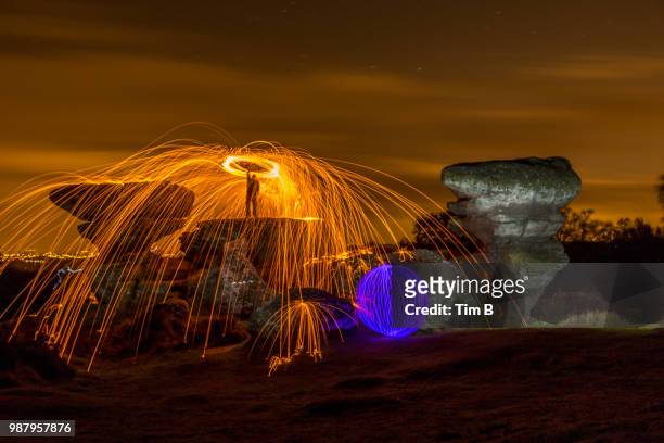 brimham rocks light painting - burning steel wool firework stock pictures, royalty-free photos & images