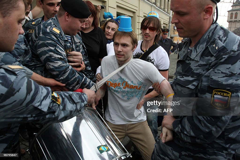 Russian riot police arrest an activist w